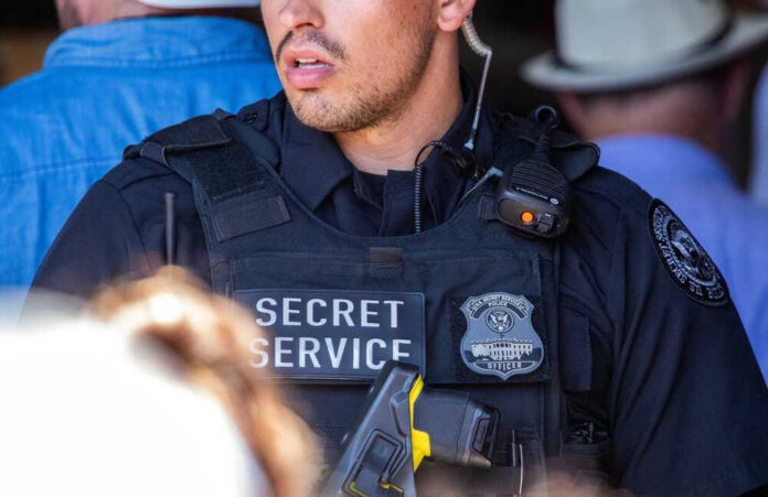 Secret Service officer in uniform with equipment visible.