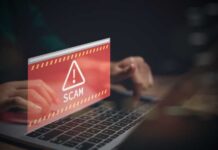 Warning message about a scam displayed on a laptop screen