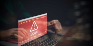 Warning message about a scam displayed on a laptop screen