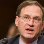 Samuel Alito speaking into a microphone.