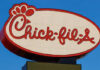 Chick-fil-A Locks The Doors — Why? Chick-fil-A restaurant sign illuminated against a blue sky