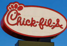 Chick-fil-A Locks The Doors — Why? Chick-fil-A restaurant sign illuminated against a blue sky