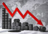 Markets Cheer As Oil Plunges Graph depicting a decline in oil prices with barrels in the foreground