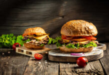 Burger Tax Panic Masks The Real Bite Gourmet burgers on rustic wooden boards with fresh toppings
