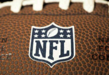 NFL Star Dead at 36 — No Answers Close-up of NFL logo on American football.