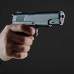 VIDEO: 3 Dead In School Horror Hand holding a semi-automatic pistol pointed forward