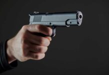 VIDEO: 3 Dead In School Horror Hand holding a semi-automatic pistol pointed forward