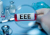 Magnifying glass over test tube labeled EEE