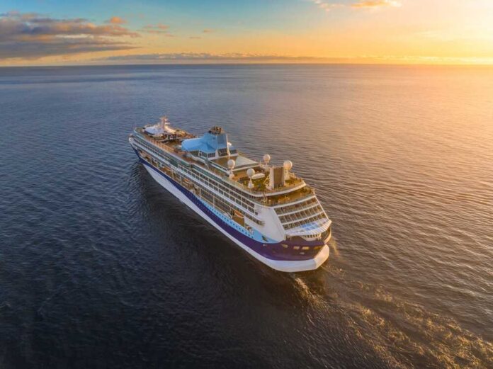 Cruise,Ship,Sailing,Across,Tranquil,Ocean,Waters,At,Sunset,With A cruise ship sailing on calm waters during sunset