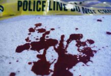UPDATE: Graduation Ceremony Turns Deadly Blood stains on a surface with police caution tape in the background