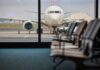 View of an airplane from an airport waiting area