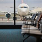 Angering Many, Airline Backtracks On Seating Policy View of an airplane from an airport waiting area