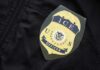 Close-up of an ICE officer badge on a black jacket