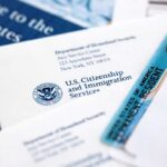 Supreme Court Greenlights Border Turnbacks USCIS documents and a green card on a table
