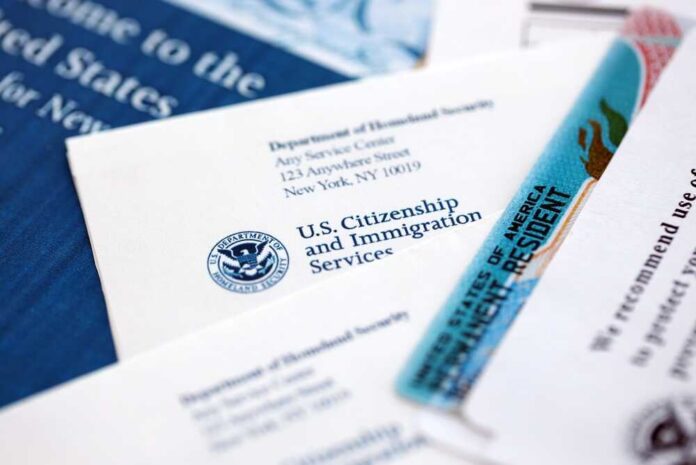 USCIS documents and a green card on a table