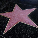 Beloved Buffy Mentor Gone — Fans Stunned A red star embedded in a black sidewalk, part of the Hollywood Walk of Fame