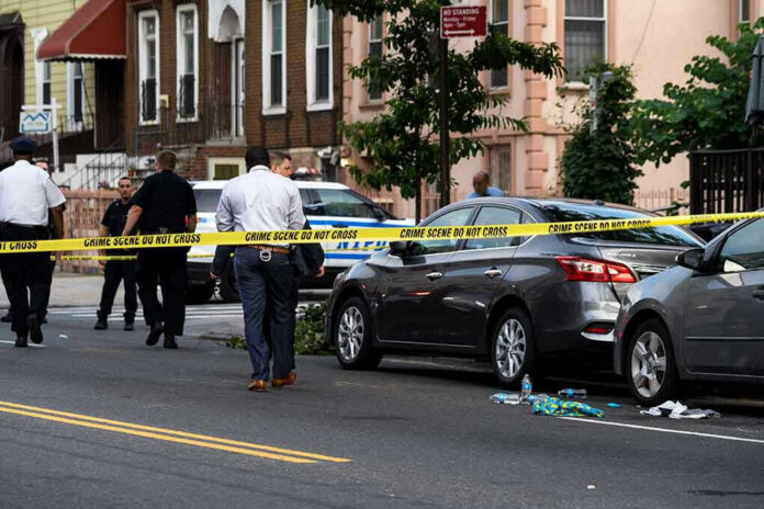 Police and crime scene tape on city street.