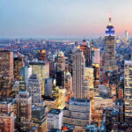 Empire Spire Stunt Turns Felony New York City skyline at dusk with skyscrapers.