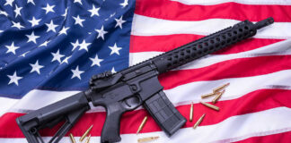 AR-15 Rifle and bullets on American flag background