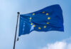 European Union flag waving against a blue sky