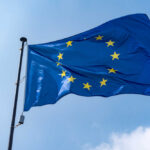 Troop Exit Threat Rattles Europe European Union flag waving against a blue sky