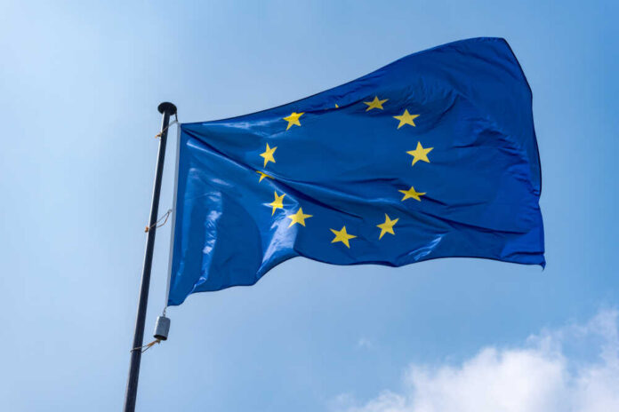 Flag,Of,European,Union,Against,Blue,Sky,. European Union flag waving against a blue sky
