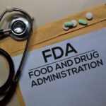 Stethoscope and medication on a folder labeled FDA