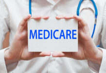 Medicare Shock: Premium Cushion Vanishing? A medical professional holding a sign that says MEDICARE