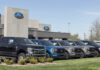 Ford dealership with trucks lined up outside