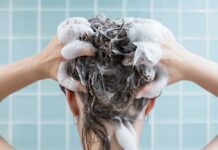 Person washing hair with shampoo lather