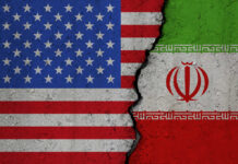 Iran Kills American Troops — U.S. Hits Back United States and Iran flags divided by crack