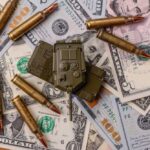 $200 Billion Bombshell Hits Congress A toy military vehicle surrounded by bullets and U.S. dollar bills