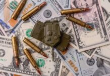 A toy military vehicle surrounded by bullets and U.S. dollar bills