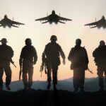 Silhouettes of soldiers and jets at sunset.