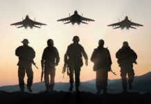 Silhouettes of soldiers and jets at sunset.