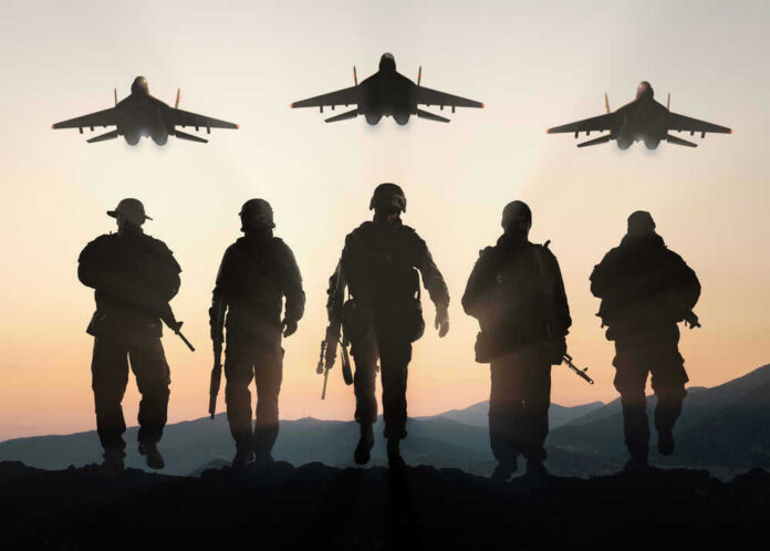 Silhouettes of soldiers and jets at sunset.