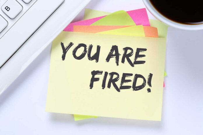 You,Are,Fired,Employee,Losing,Jobs,,Job,Working,Unemployed,Business A sticky note with the message 'YOU ARE FIRED!' placed on a desk next to a keyboard and a cup of coffee