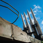 Surface-to-air missiles mounted on a military launcher under a blue sky