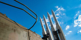 Surface-to-air missiles mounted on a military launcher under a blue sky