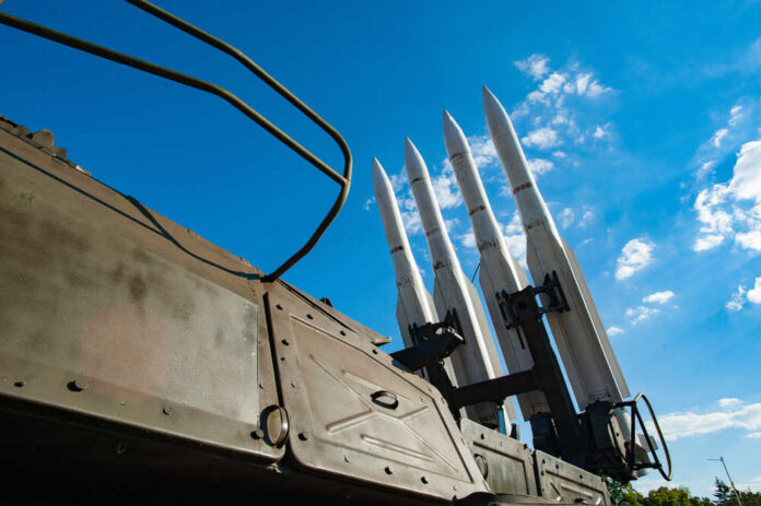 Surface-to-air missiles mounted on a military launcher under a blue sky