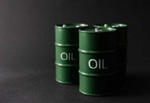 Trump’s Oil Coup Stuns Markets Green oil barrels on a dark background