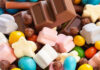 Colorful candies and chocolate bar close-up.