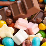 Colorful candies and chocolate bar close-up.
