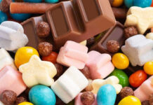 Colorful candies and chocolate bar close-up.