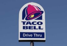 Taco Bell drive-thru sign against a clear blue sky