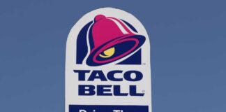Taco Bell drive-thru sign against a clear blue sky