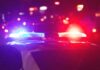 Police car with flashing red and blue lights at night