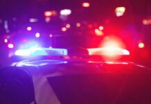 Police car with flashing red and blue lights at night