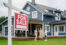 Bidding Wars Up Top, Crickets Below For sale sign in front of a house with potential buyers discussing