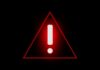 Red warning triangle with exclamation mark on black background